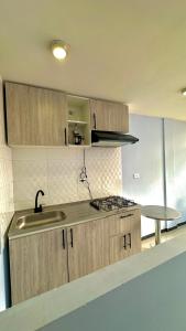 a kitchen with a sink and a stove in it at LourdesInn65 in Bogotá