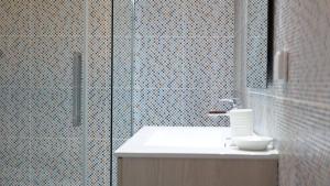 a bathroom with a sink and a glass shower at Porto Plage de Matosinhos in Matosinhos +63 photos