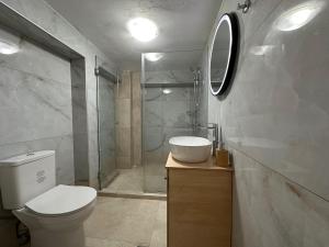 a bathroom with a toilet and a sink and a shower at Evdilos blue serenity by BRP-PROPERTIES in Evdilos +23 photos
