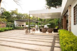 a house with a dog standing on a patio at Amalfi Surf Lodge in ChiltiupÃ¡n