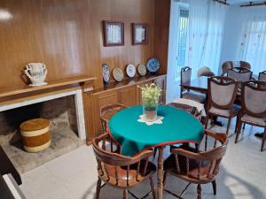a dining room with a table and chairs and a fireplace at Chalet Kathia Minigolf, Ping-pong y más in Las Torres de Cotillas