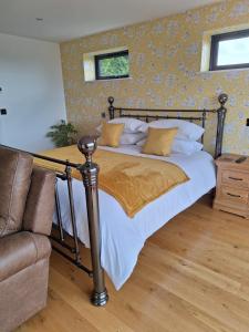 a bedroom with a bed and a couch at Room with a View in Glastonbury