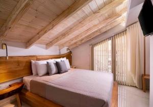 a bedroom with a large bed and a large window at Lena Apartments Potos Thassos in Potos +58 photos