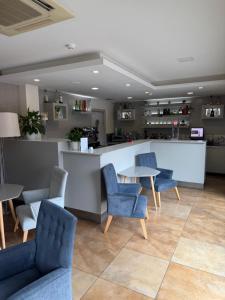 a waiting room with chairs and a table and a counter at Hotel Albergaria Borges in Chaves