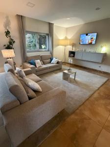 a living room with a couch and a tv at Hotel Albergaria Borges in Chaves