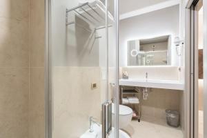 a bathroom with a shower and a toilet and a sink at Baires Guest House 2 in Milan +19 photos