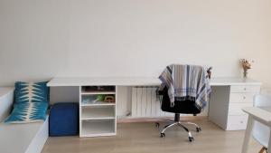 a bedroom with a bed and a desk and a chair at Sevan lake view in Tsovagyugh