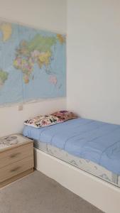a bed in a room with a map on the wall at Sevan lake view in Tsovagyugh