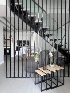 a living room with a table and a staircase at Harmonia Guest House in Ponta Delgada +16 photos