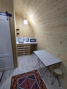a small room with a table and a counter at Swallow in Karakol +9 photos