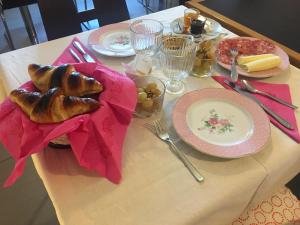 a table with a plate of food on it at Villa Varenna in Varenna