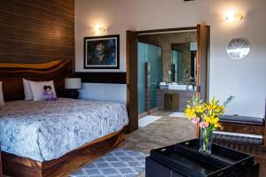 a bedroom with a bed and a large mirror at Hotel Matea San Isidro in Tonatico +41 photos