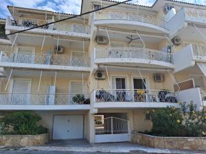 an apartment building with balconies on the side at Blue Dreams Astros in Paralio Astros