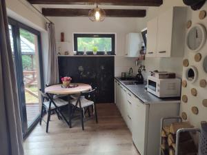 a small kitchen with a table and a microwave at Bieszczadzkie Asy in Polana