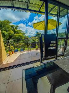 a patio with a table and a yellow umbrella at Apartamento turistico diana in La Tebaida