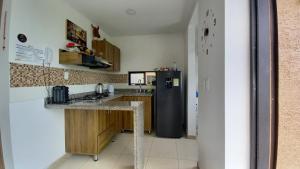 a kitchen with a refrigerator and a counter top at Apartamento turistico diana in La Tebaida