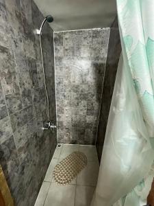 a bathroom with a shower with a shower curtain at Central Apartment in Cochrane