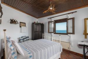 a bedroom with a bed and a window at Dust in The Wind Sunrise in Triovasálos