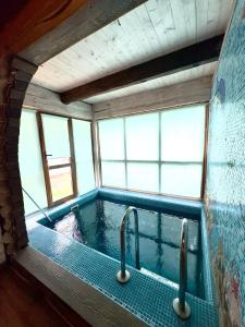a bath tub with two faucets in a room at Villa Trypill in Tripolʼye