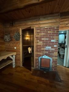 a fireplace in a room with a brick wall at Villa Trypill in Tripolʼye