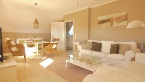 a living room with a white couch and a table at Haus Jonas in Tinnum