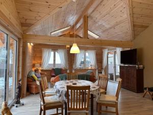a dining room with a table and chairs and a living room at Ferienhaus 4 Elemente in Selchow mit tollem Garten in Selchow