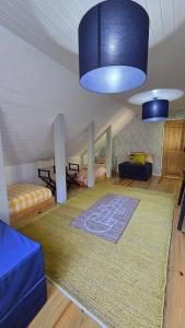 a living room with a rug and a blue light at Ferreirinha Valley in Vieira do Minho
