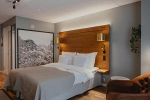 a bedroom with a large bed with a wooden headboard at Home Hotel Temperance in Malmö