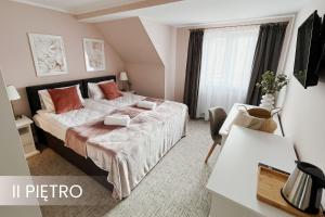 a bedroom with a large bed and a window at Villa Adele in Polanica-Zdrój