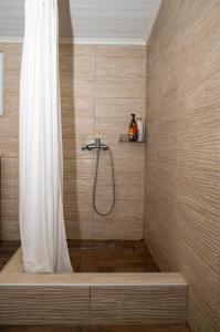 a shower with a white shower curtain in a bathroom at Green Yard House in Alexandroupoli +81 photos