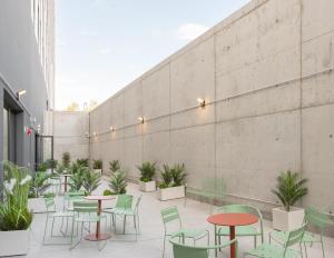 a patio with tables and chairs and plants at Stephouse Girona Tarradellas in Girona