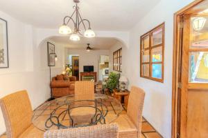 a dining room with a glass table and chairs at Casa Hidalgo Hideaway in Chapala