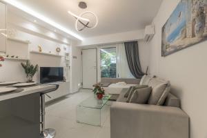 a living room with a couch and a table at varkiza luxury 2BD apartment in Varkiza