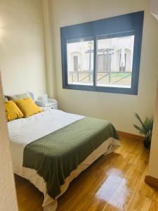 a bedroom with a large bed and a window at La Escapada in El Ronquillo +17 photos