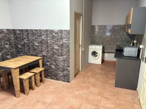 a kitchen with a table and a washer and dryer at Хостел Гора in Kharkiv +30 photos
