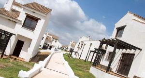 a row of white houses with a sky background at La Escapada in El Ronquillo