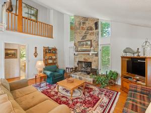 a living room with a couch and a fireplace at Clear Creek Escape - Double Decker Dock, New Green Fishing Lights! in Jasper