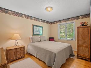 a bedroom with a bed and a dresser and a window at Clear Creek Escape - Double Decker Dock, New Green Fishing Lights! in Jasper