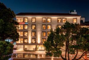 a building with lights on in a city at night at Hampton By Hilton Cusco in Cusco