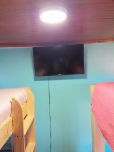 a room with two bunk beds and a flat screen tv at Apartamento Cuadruple in Isla de Maipo +9 photos