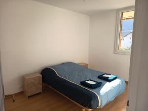 a bedroom with a bed in a room with a window at MaMontagne in Albertville