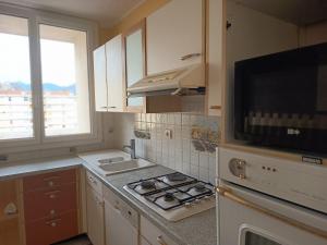 a kitchen with a stove and a microwave at MaMontagne in Albertville