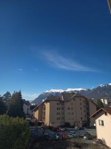 a view of a building with mountains in the background at MaMontagne in Albertville
