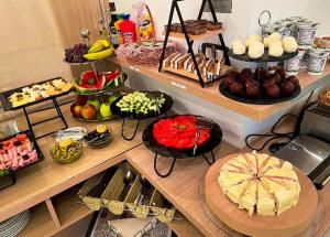 a table with many different types of food on it at Meridian Hotel in Budva +23 photos