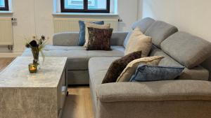 a living room with two couches and a coffee table at Aaron27 in Meißen