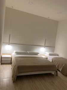 a bedroom with two beds and two lights at  