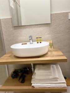 a white sink on a wooden counter in a bathroom at  