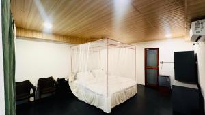 a room with a bed with a canopy in it at Patnem Garden Resort in Patnem