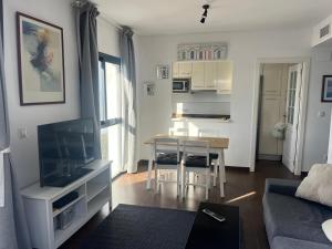 a living room with a table and a dining room at over the sea in El Morche