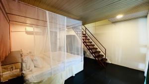 a room with a glass wall and a staircase at Patnem Garden Resort in Patnem